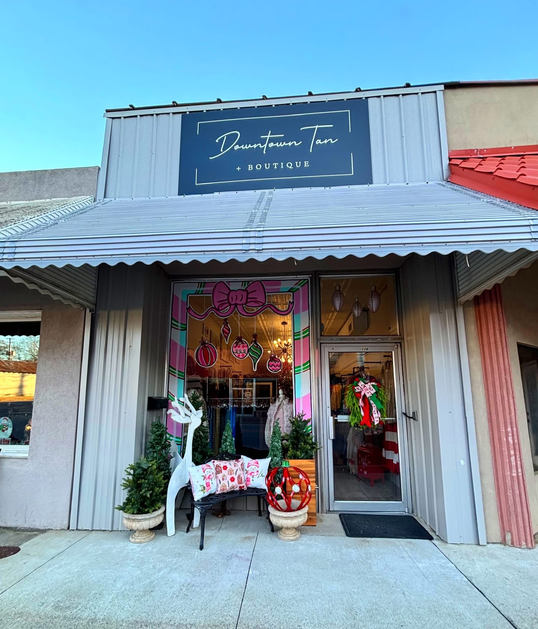 Boutique storefront with signage and holiday decorations